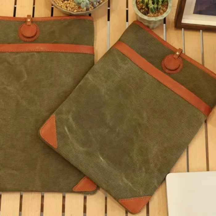 Lightweight Leather Canvas Sleeve in Olive Green (15-inch model) with close-up of the hand-stitched leather and canvas join.