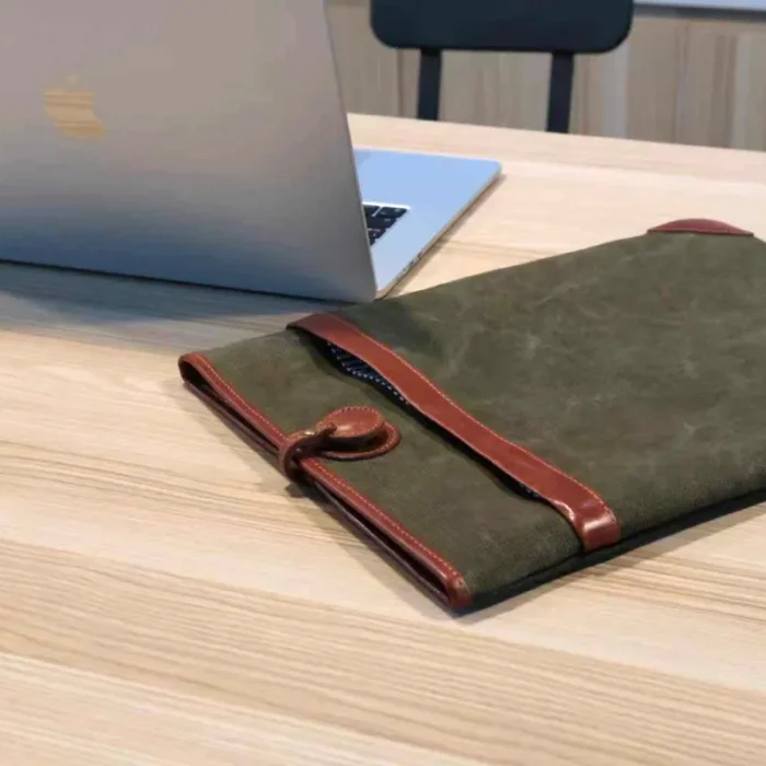 Lightweight Leather Canvas Sleeve in Olive Green (15-inch model) with close-up of the hand-stitched leather and canvas join.