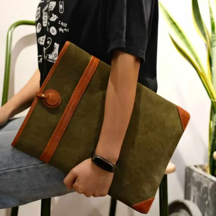 Lightweight Leather Canvas Sleeve in Olive Green (15-inch model) with close-up of the hand-stitched leather and canvas join.