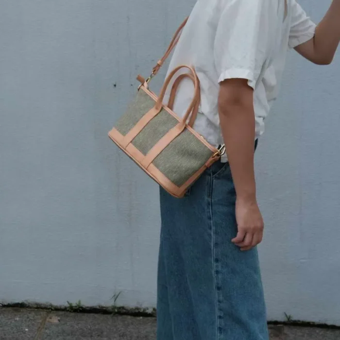 Lifestyle photo: Casual styling of the Poplar Green SYMONHO canvas tote paired with classic jeans, highlighting its everyday aesthetic.